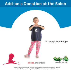 A girl wearing a St. Jude donation shirt and forming a heart with her hands