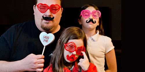 A family wearing fun Valentine's Day decorations.